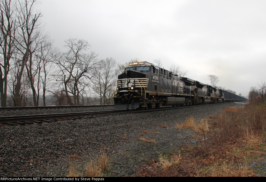 NS 4756 leads train 63V with trash down the siding
